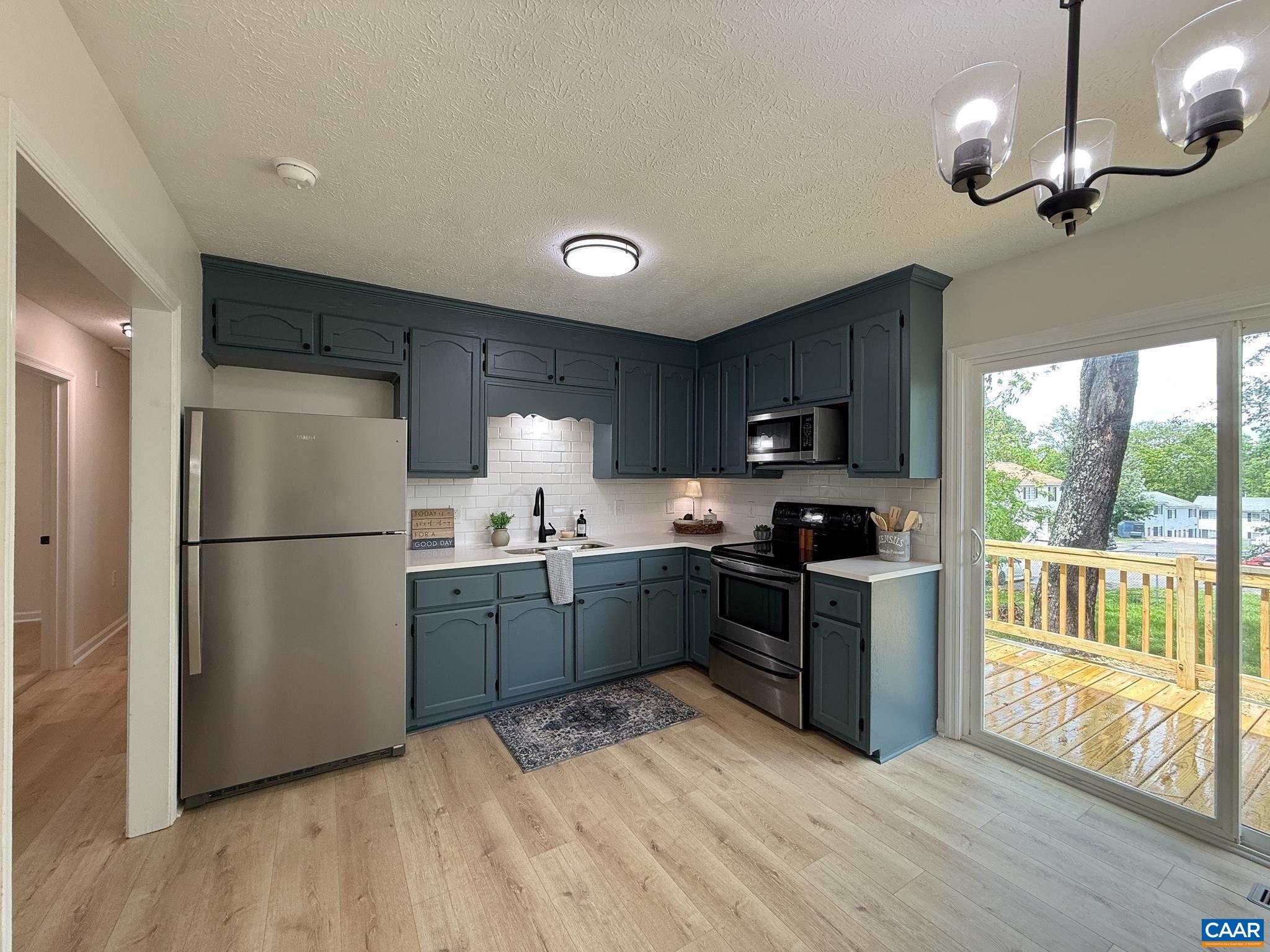 1207 4th Street Waynesboro, VA 22980 - Photo 4 of 18 a kitchen with granite countertop stainless steel appliances a refrigerator a stove a sink a center island and furniture