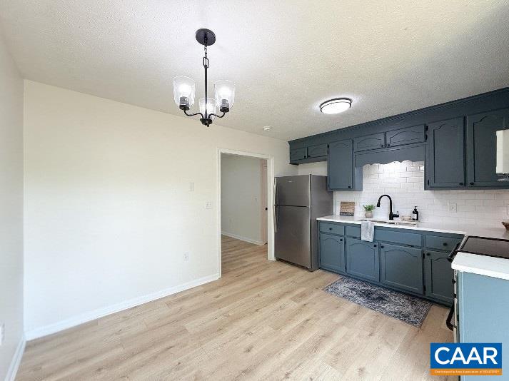1207 4th Street Waynesboro, VA 22980 - Photo 5 of 18 a kitchen with stainless steel appliances granite countertop a sink cabinets and wooden floor