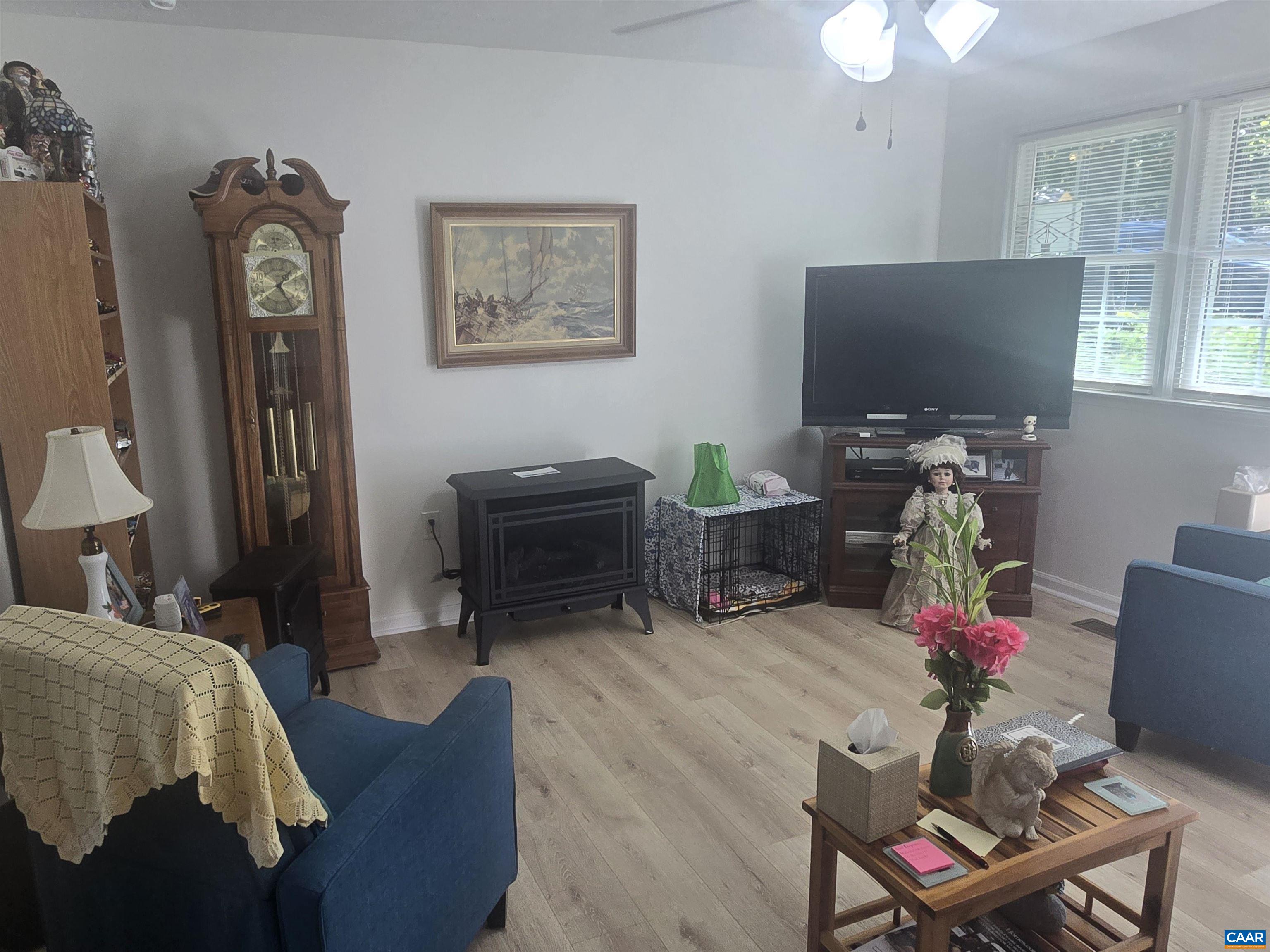 1207 4th Street Waynesboro, VA 22980 - Photo 8 of 18 a living room with furniture a chandelier and a flat screen tv