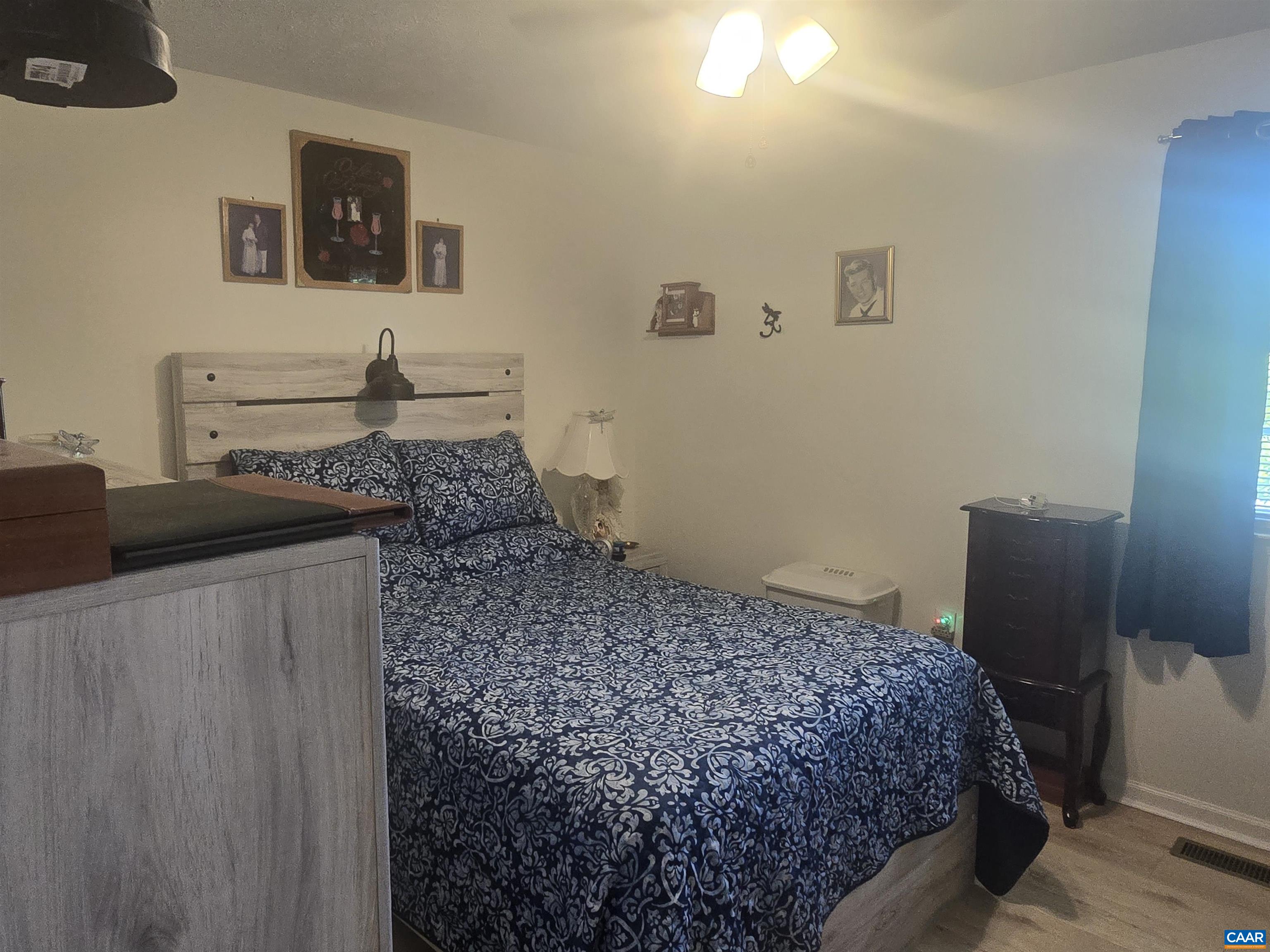 1207 4th Street Waynesboro, VA 22980 - Photo 10 of 18 a bedroom with a bed and wooden floor