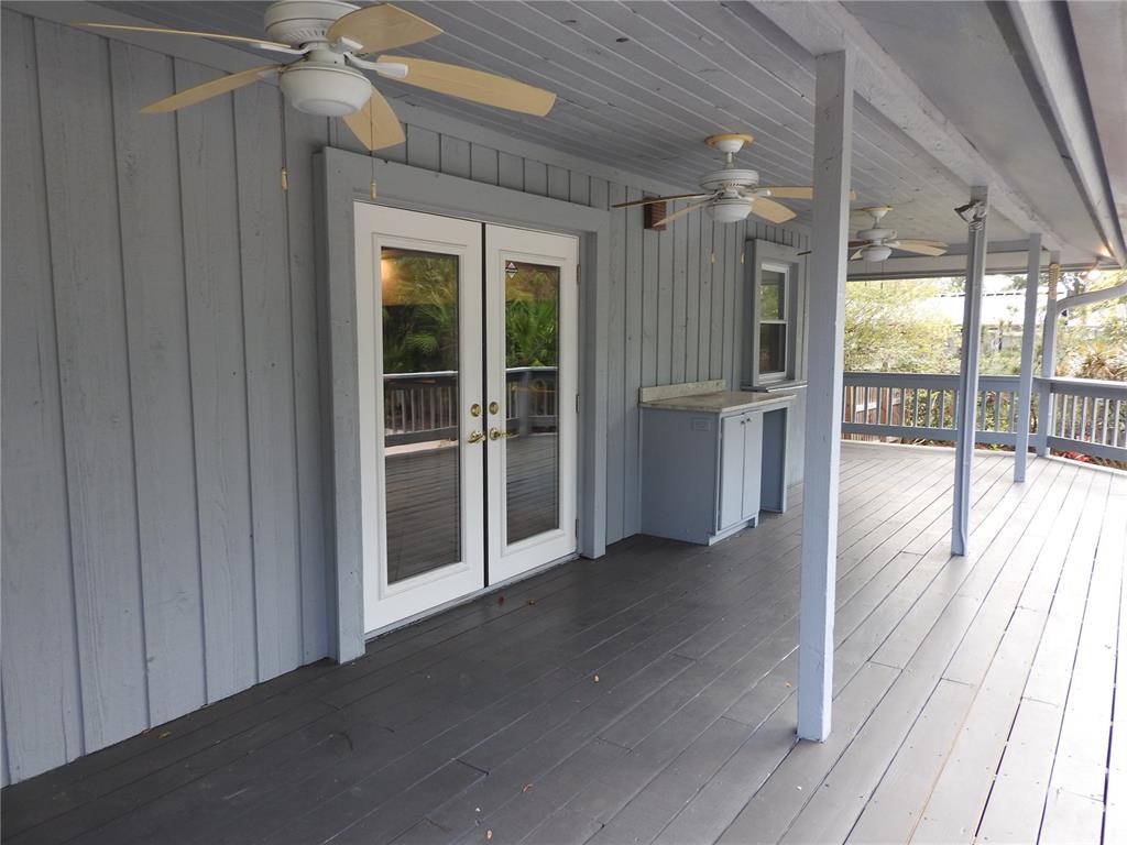 8308 Beasley Road Tampa, FL 33615 - Photo 11 of 49 a view of a big room with wooden floor and windows