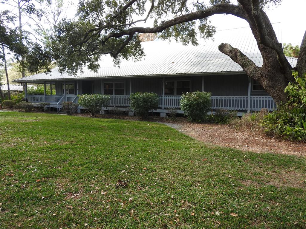 8308 Beasley Road Tampa, FL 33615 - Photo 2 of 49 a view of a yard in front of a house with large tree