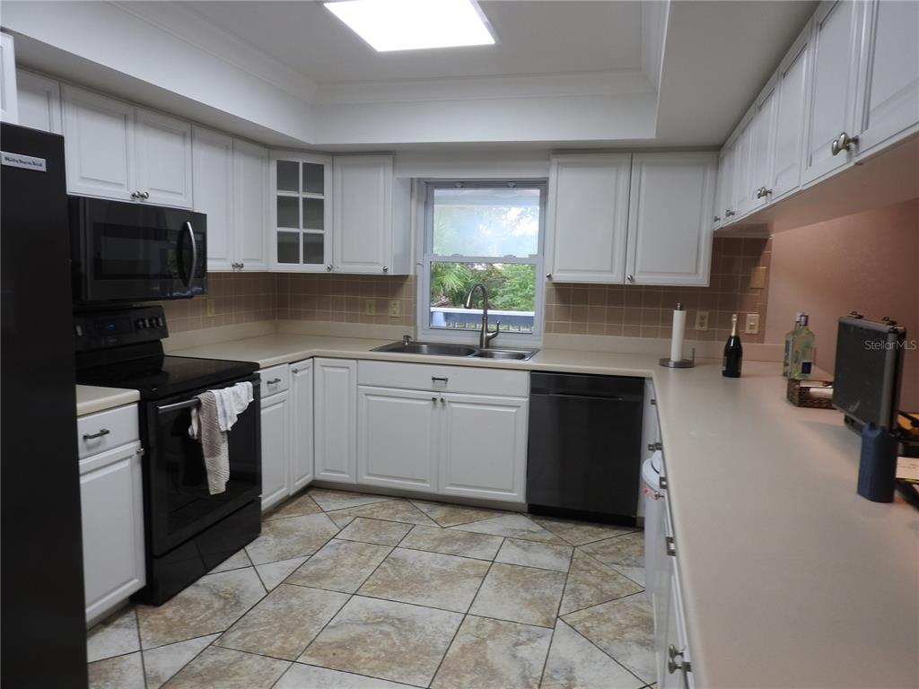 8308 Beasley Road Tampa, FL 33615 - Photo 26 of 49 a kitchen with a sink stove and refrigerator