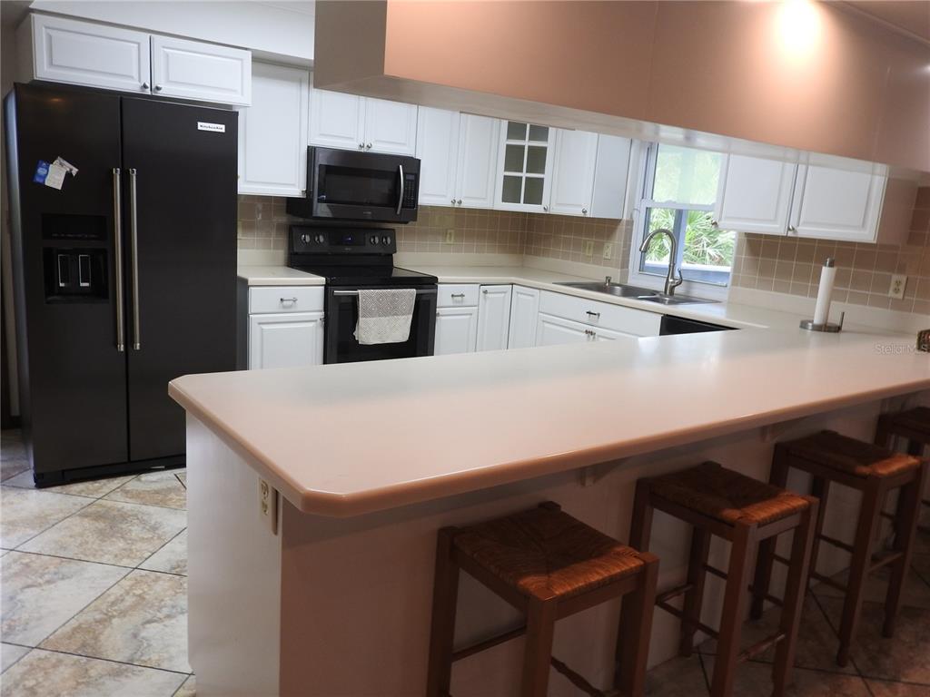 8308 Beasley Road Tampa, FL 33615 - Photo 28 of 49 a kitchen with stainless steel appliances a refrigerator and a stove top oven