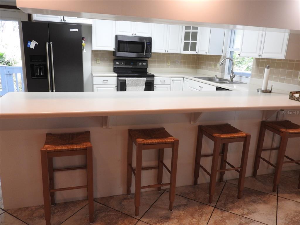 8308 Beasley Road Tampa, FL 33615 - Photo 29 of 49 a kitchen with cabinets and chairs in it