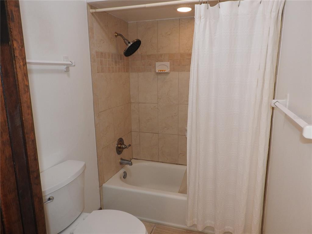 8308 Beasley Road Tampa, FL 33615 - Photo 44 of 49 a bathroom with a toilet and a bathtub