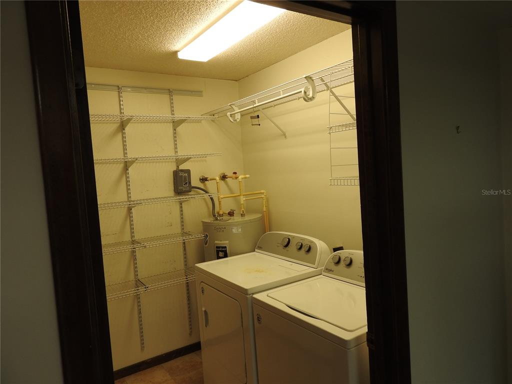 8308 Beasley Road Tampa, FL 33615 - Photo 47 of 49 a bathroom with a sink and mirror with shower