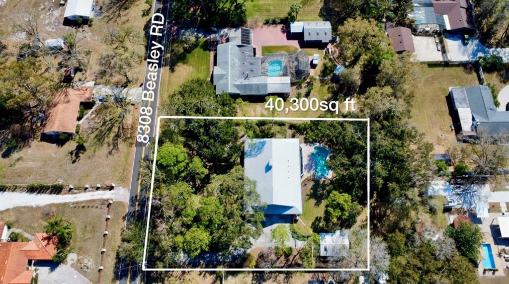 8308 Beasley Road Tampa, FL 33615 - Photo 49 of 49 an aerial view of a house with a garden and swimming pool