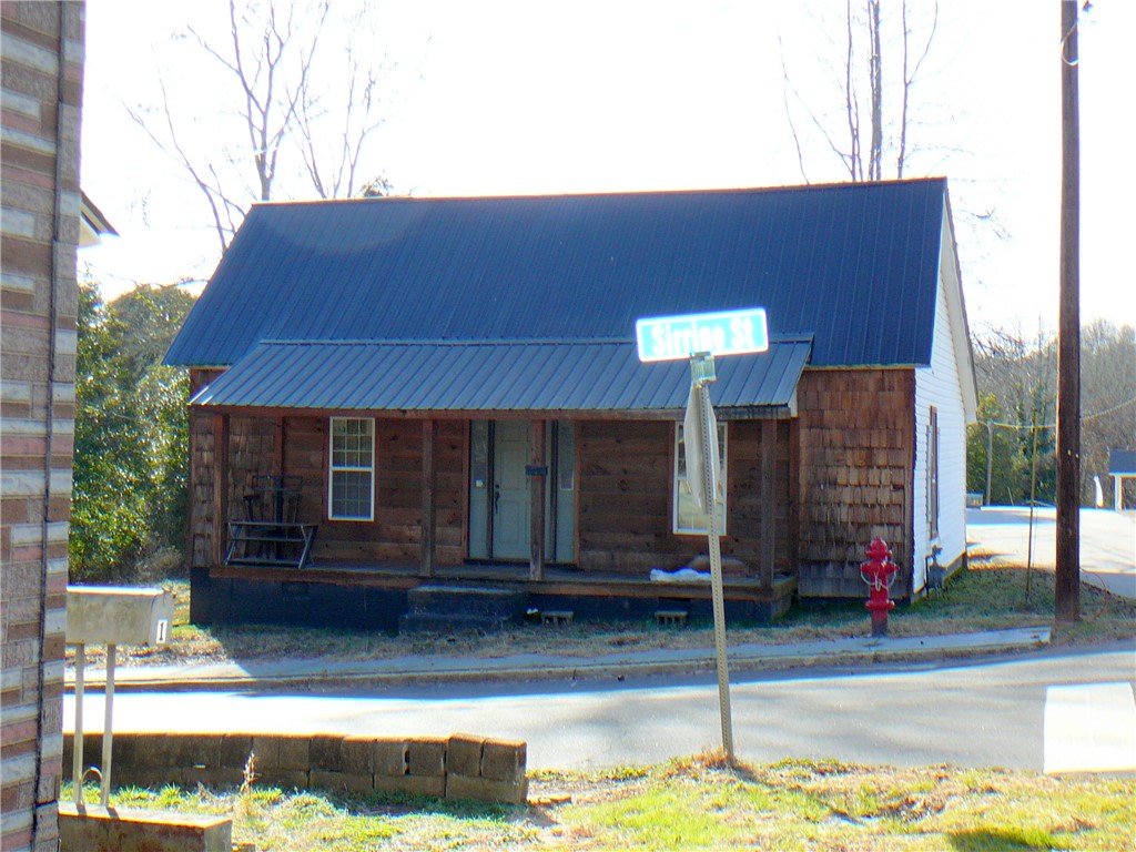 This charming home offers rustic appeal with its inviting front porch.