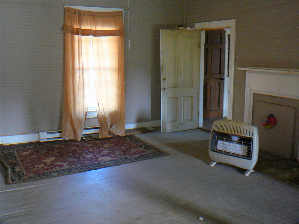2 Sirrine Street Honea Path, SC 29654 - Photo 7 of 10 This interior space features hardwood floors and a window, offering a versatile living area.