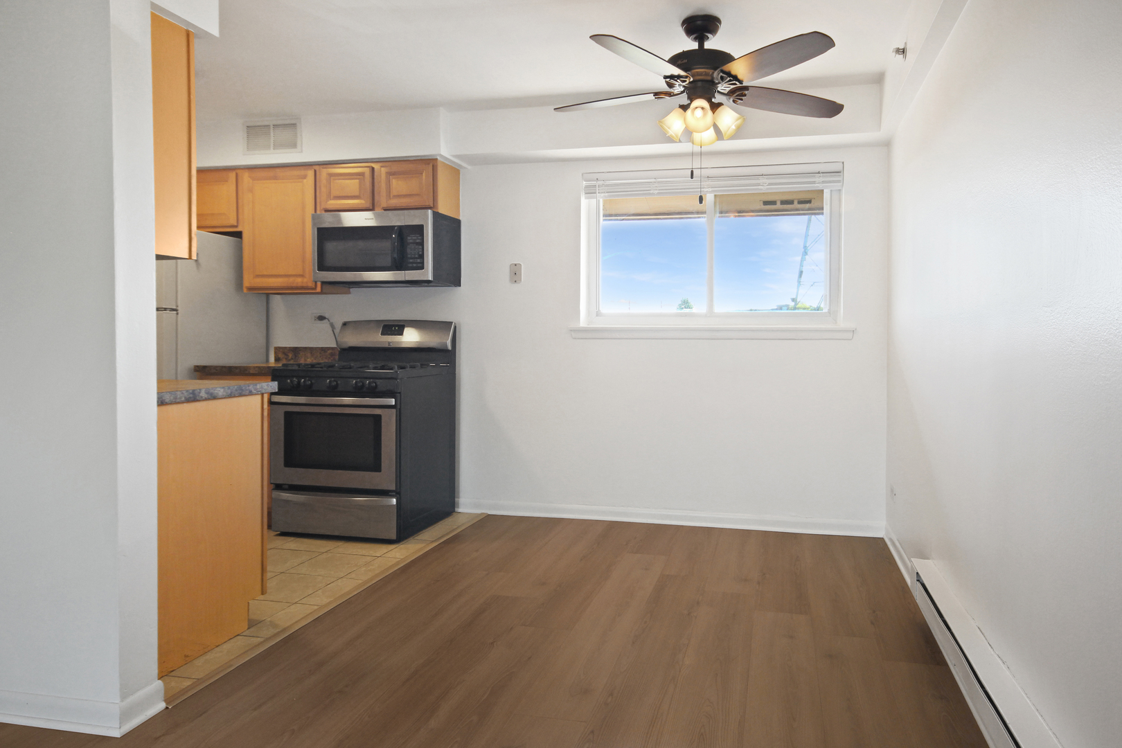 1900 Knights Bridge Drive, Unit 2B Mount Prospect, IL 60056 - Photo 11 of 16 a kitchen with stainless steel appliances a stove microwave and refrigerator