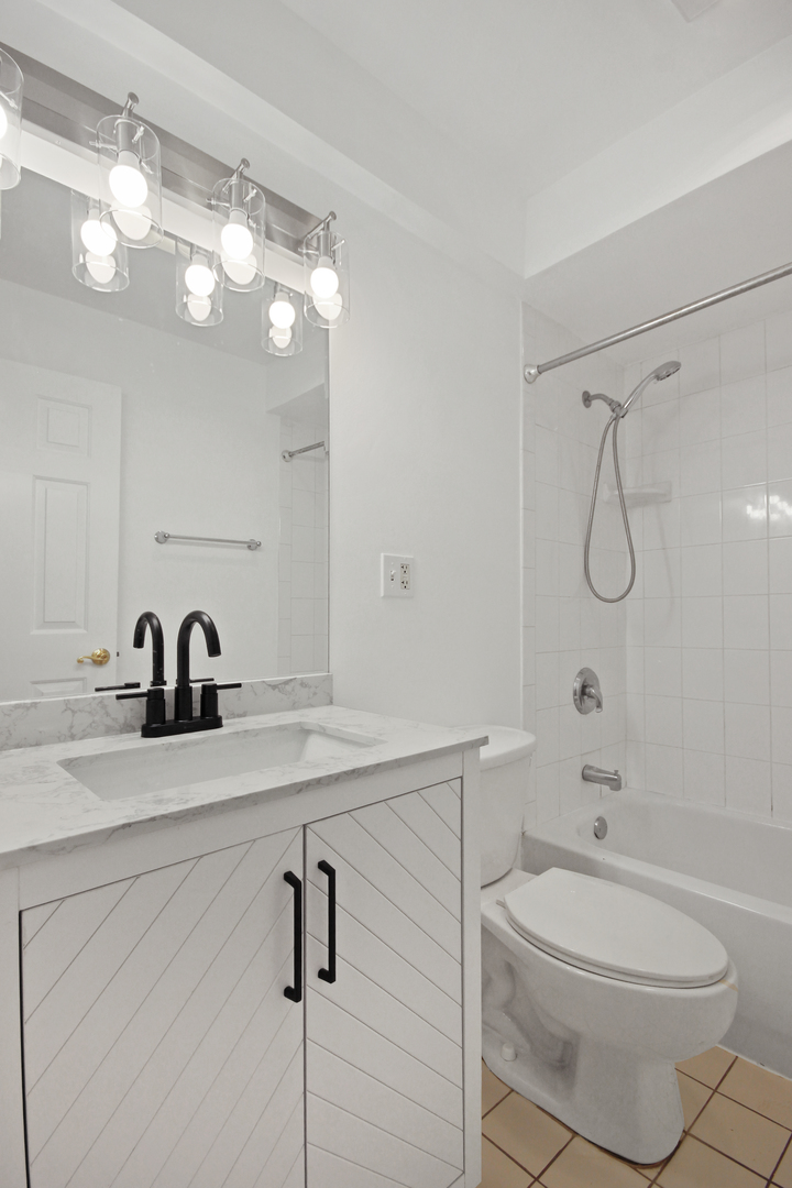 1900 Knights Bridge Drive, Unit 2B Mount Prospect, IL 60056 - Photo 13 of 16 a bathroom with a granite countertop sink a toilet and a mirror