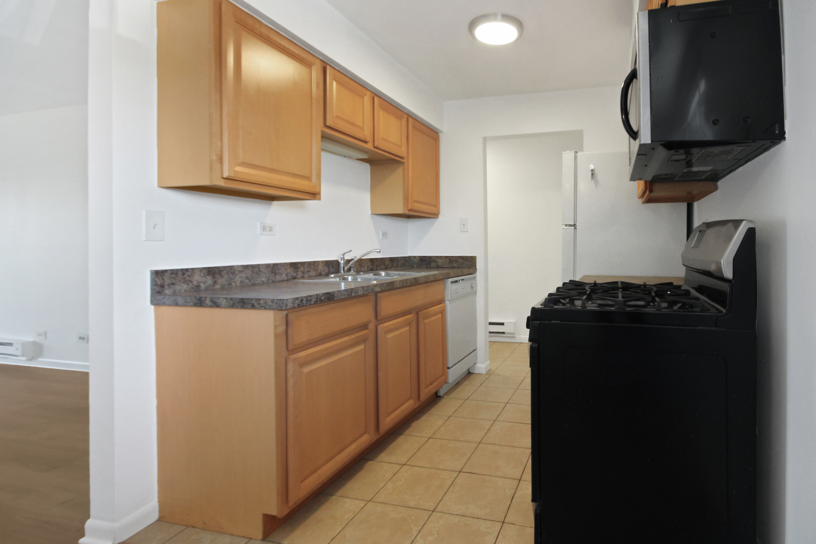 1900 Knights Bridge Drive, Unit 2B Mount Prospect, IL 60056 - Photo 10 of 16 a kitchen with stainless steel appliances granite countertop a refrigerator and a stove