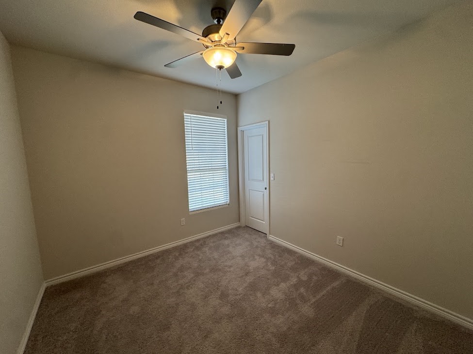 2658 Westeros Street Corpus Christi, TX 78415 - Photo 6 of 13 an empty room with a window and a fan