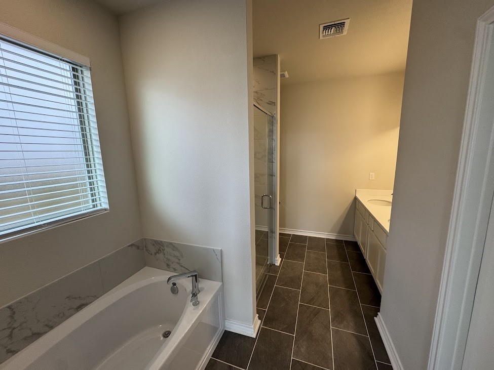 2658 Westeros Street Corpus Christi, TX 78415 - Photo 10 of 13 a bathroom with a bathtub and a shower