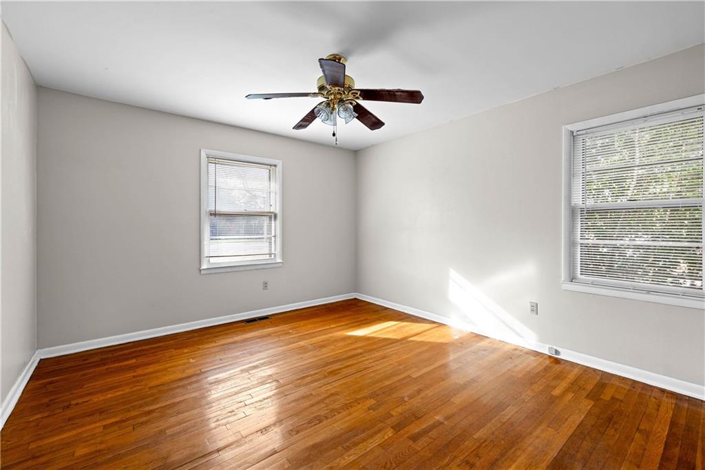 104 Denham Street Thomaston, GA 30286 - Photo 14 of 26 a view of an empty room with wooden floor and a window