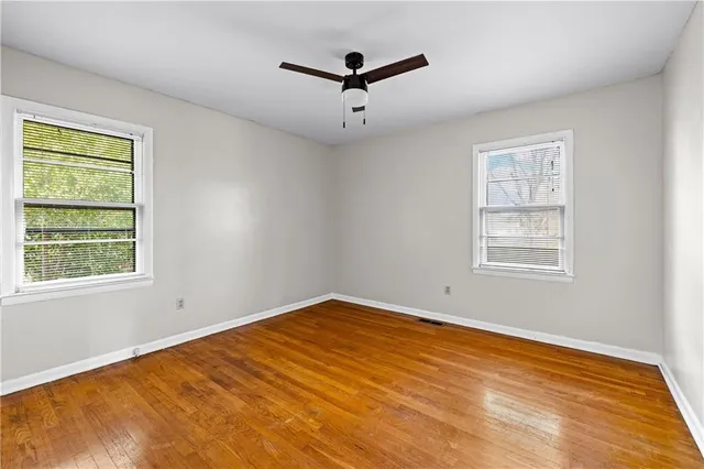 a view of a room with a window and a ceiling fan