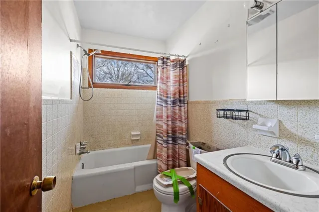 a bathroom with a sink a mirror a toilet and bathtub