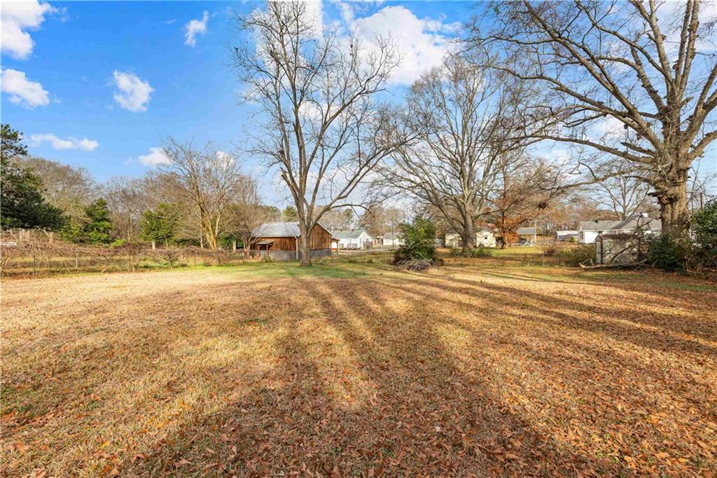 104 Denham Street Thomaston, GA 30286 - Photo 25 of 26 a view of road with covered with trees
