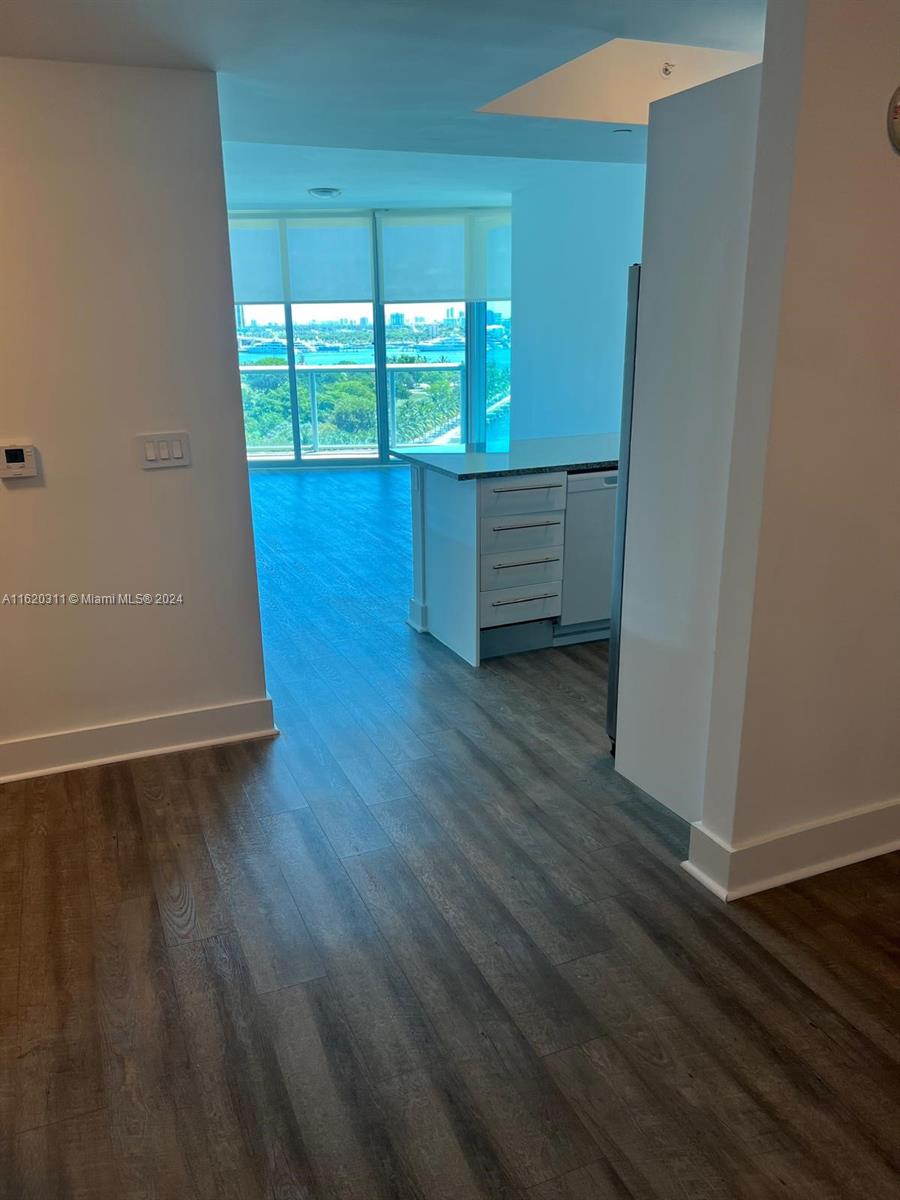 888 Biscayne Boulevard, Unit 509 Miami, FL 33132 - Photo 11 of 32 wooden floor in an empty room with a window