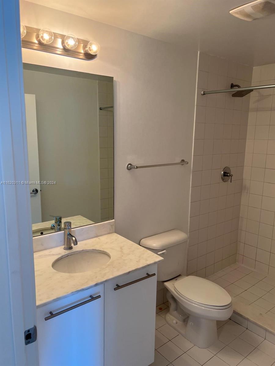 888 Biscayne Boulevard, Unit 509 Miami, FL 33132 - Photo 12 of 32 a bathroom with a sink toilet and shower