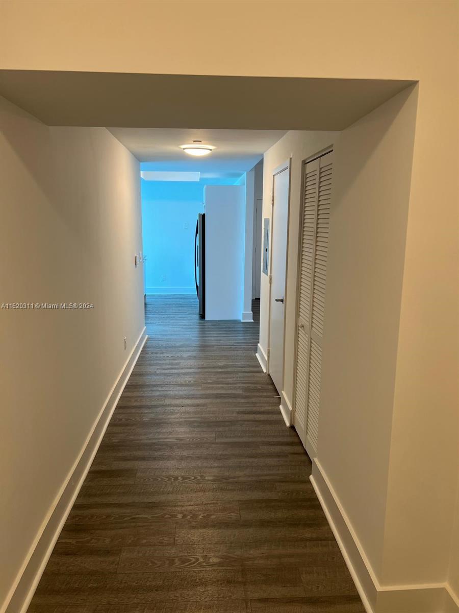 888 Biscayne Boulevard, Unit 509 Miami, FL 33132 - Photo 15 of 32 a view of a hallway with wooden floor