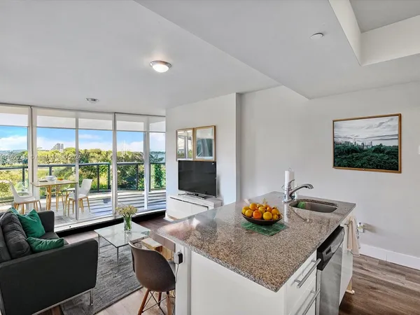 a kitchen with stainless steel appliances granite countertop a sink a stove and a refrigerator