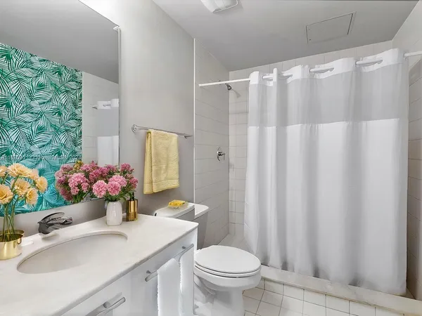 a bathroom with a sink toilet and shower