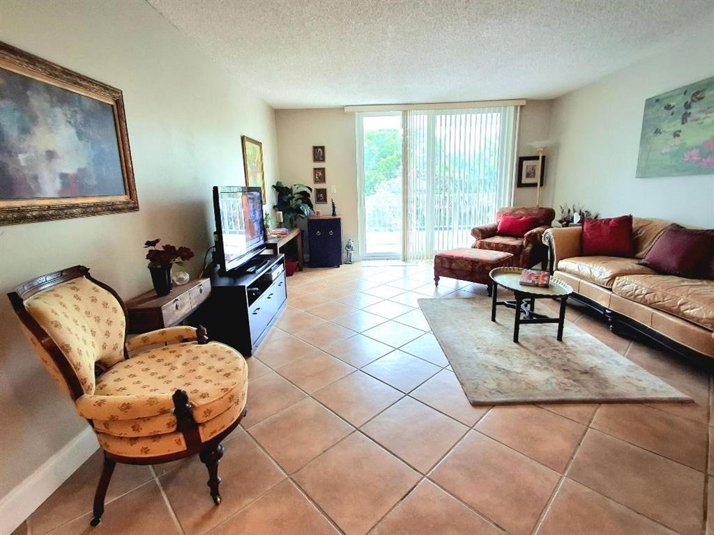 1421 South Ocean Boulevard, Unit 206 Pompano Beach, FL 33062 - Photo 3 of 40 a living room with furniture and a large window