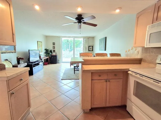 a kitchen with a stove sink and cabinets