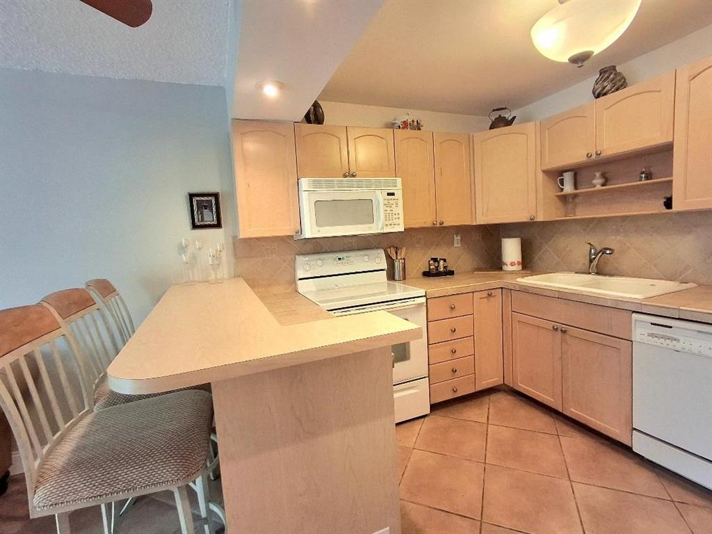 1421 South Ocean Boulevard, Unit 206 Pompano Beach, FL 33062 - Photo 9 of 40 a kitchen with cabinets and window