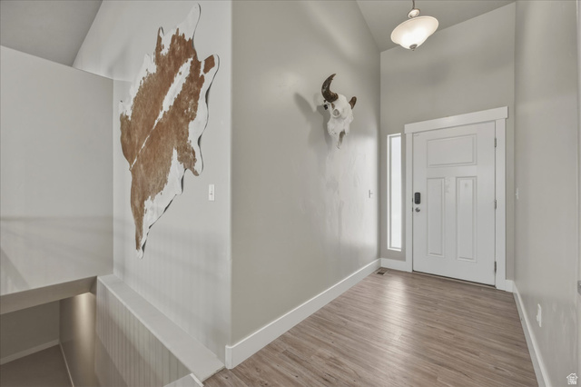 45 Memory Lane Tooele, UT 84074 - Photo 6 of 30 Front door entryway with wood finished floors and vaulted ceiling