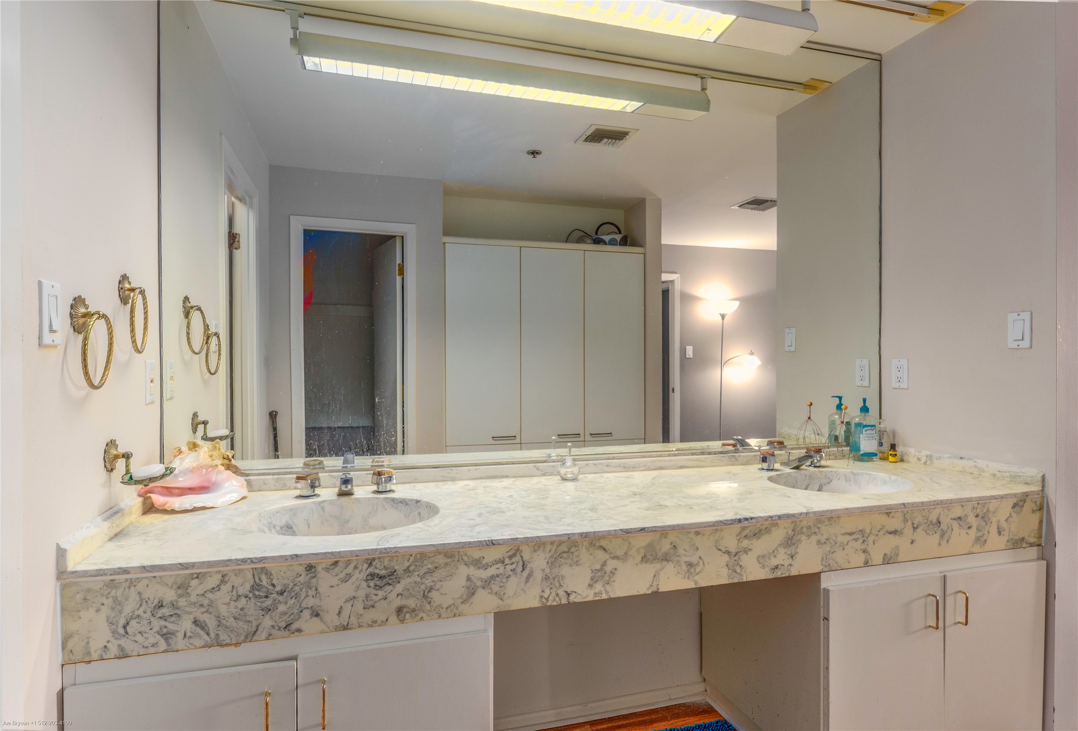 40 North Interstate Highway 35, Unit 6C1 Austin, TX 78701 - Photo 19 of 37 a bathroom with a granite countertop sink a large mirror and vanity