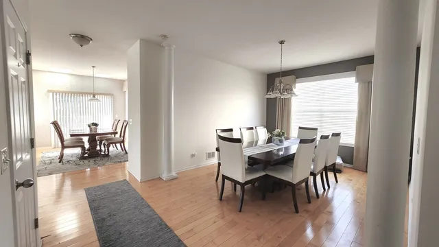 a view of a dining room with furniture and a window