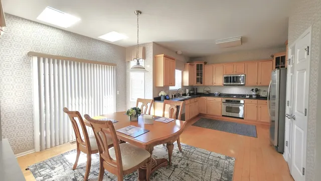 a view of a dining room with furniture window and wooden floor