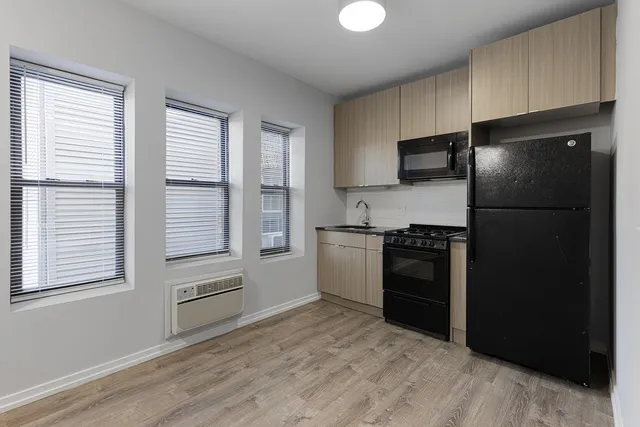a kitchen with a refrigerator and a stove