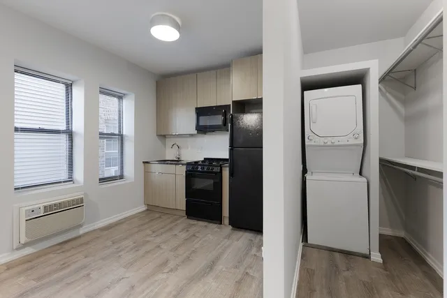 a kitchen with a refrigerator and a stove top oven