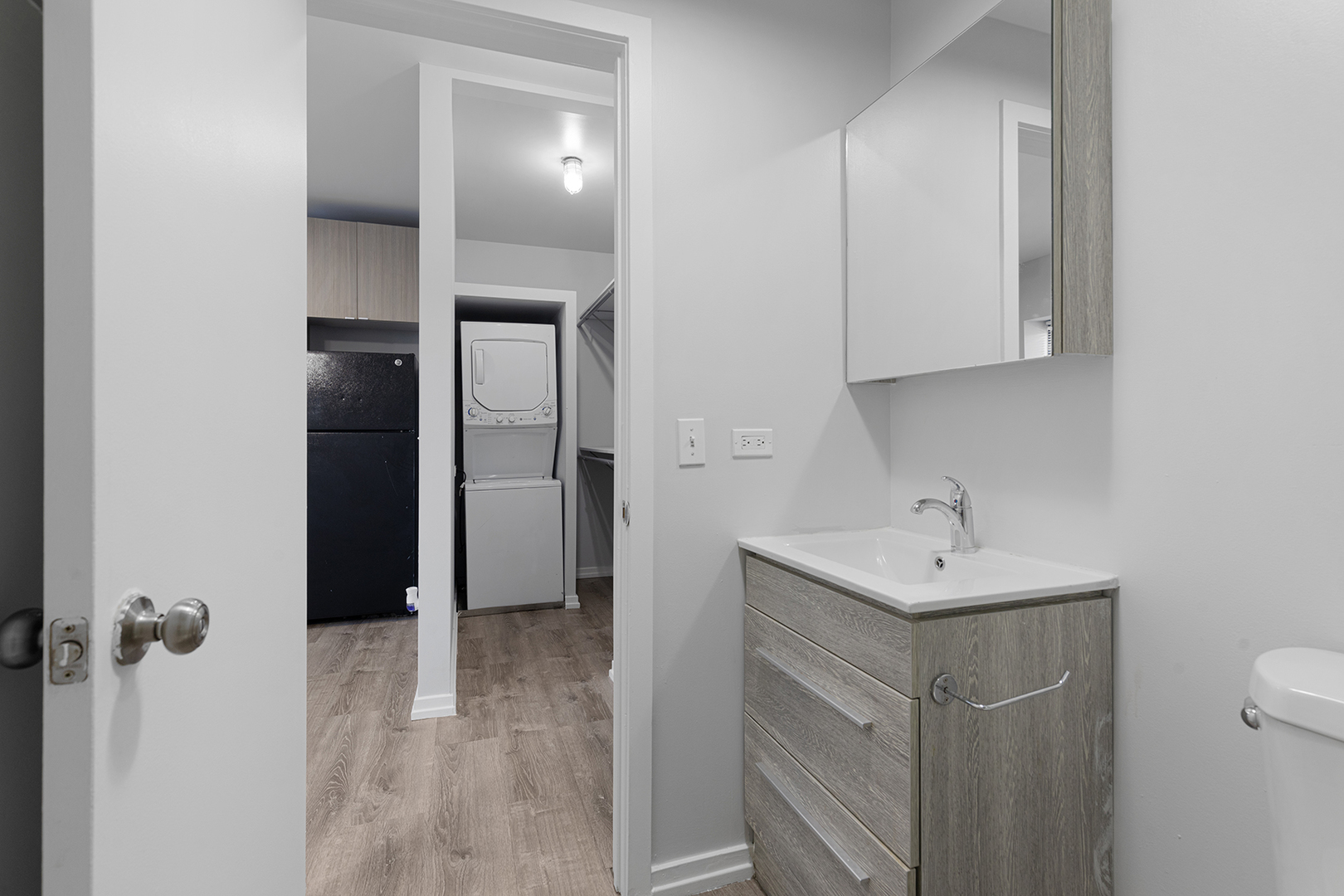 4875 North Magnolia Avenue, Unit 320 Chicago, IL 60640 - Photo 6 of 11 a bathroom with a sink a toilet and mirror