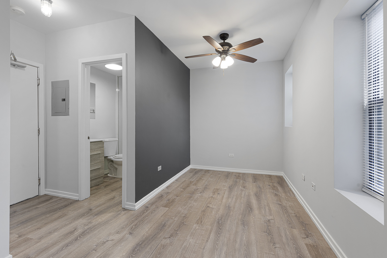 4875 North Magnolia Avenue, Unit 320 Chicago, IL 60640 - Photo 7 of 11 wooden floor in an empty room with a window