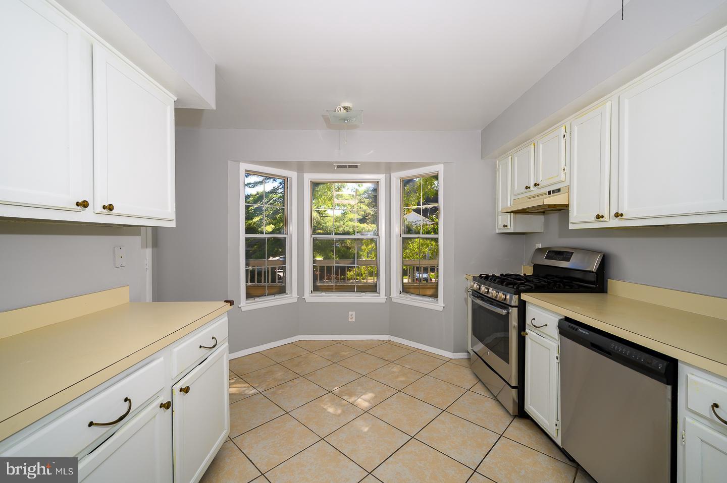 115 Cascade Court, Unit 7 Princeton, NJ 08540 - Photo 15 of 27 a kitchen with granite countertop white cabinets and white appliances