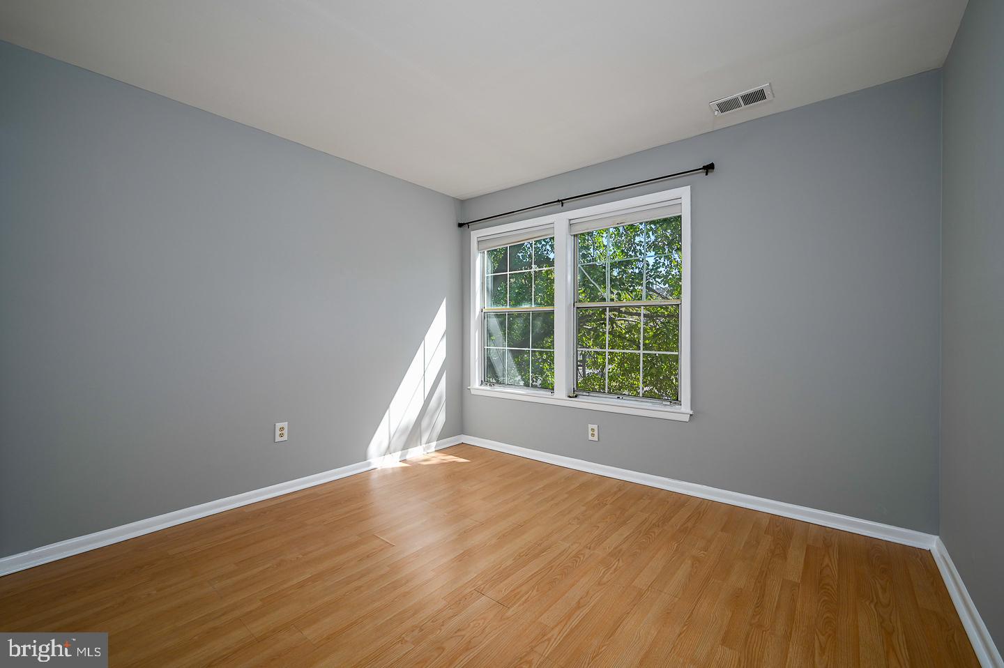 115 Cascade Court, Unit 7 Princeton, NJ 08540 - Photo 19 of 27 a view of an empty room with wooden floor and a window