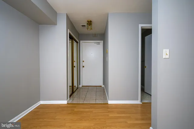 a view of empty room with wooden floor and fireplace