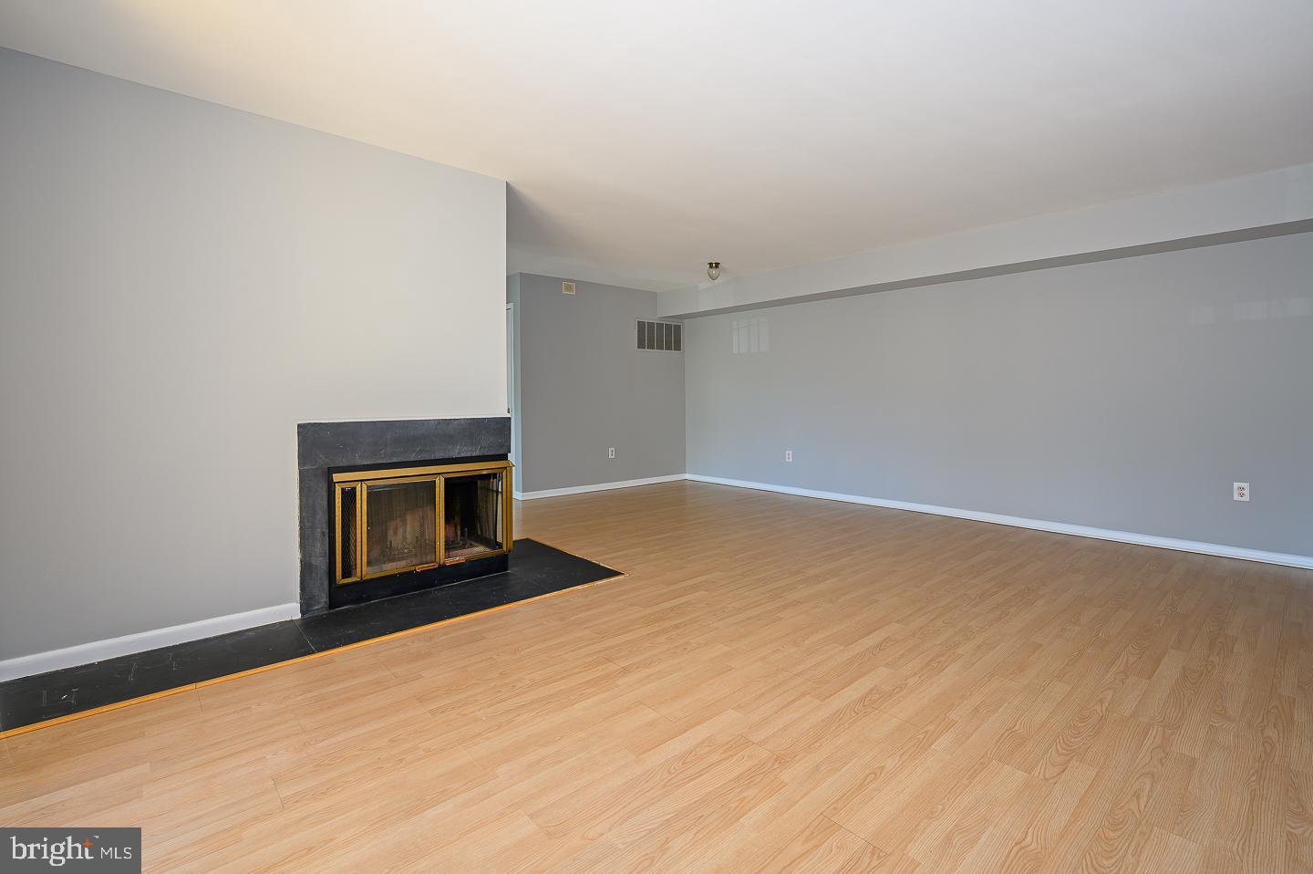 115 Cascade Court, Unit 7 Princeton, NJ 08540 - Photo 6 of 27 a view of empty room with wooden floor and fireplace