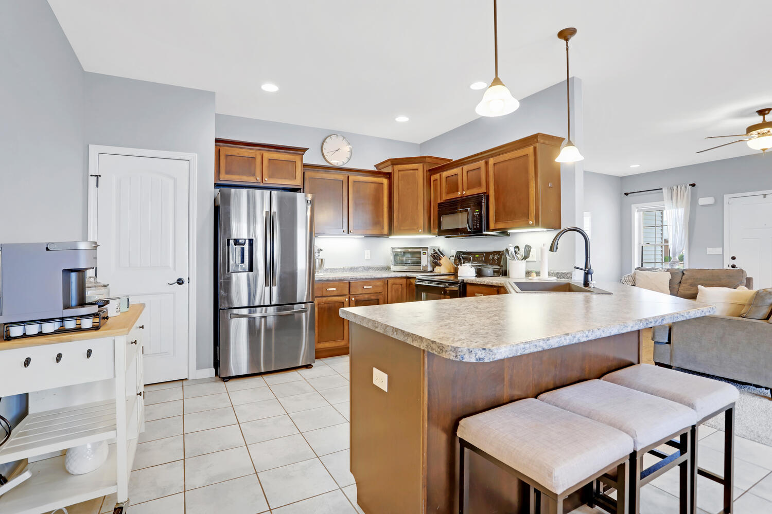 3323 Boulder Ridge Drive Champaign, IL 61822 - Photo 12 of 27 a kitchen with stainless steel appliances granite countertop a sink a stove a refrigerator cabinets a dining table and chairs