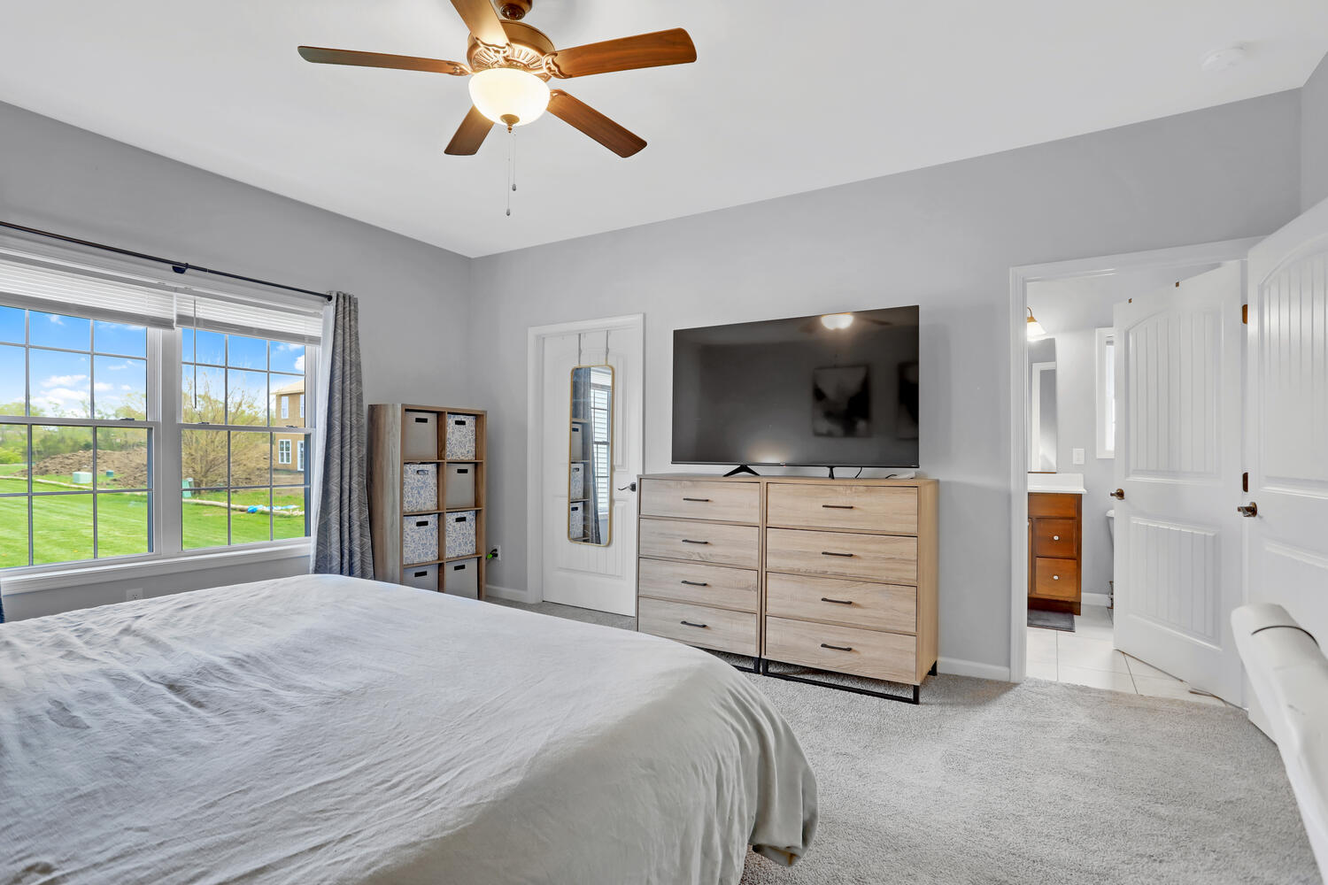 3323 Boulder Ridge Drive Champaign, IL 61822 - Photo 17 of 27 a bedroom with a bed a flat screen tv and a chandelier