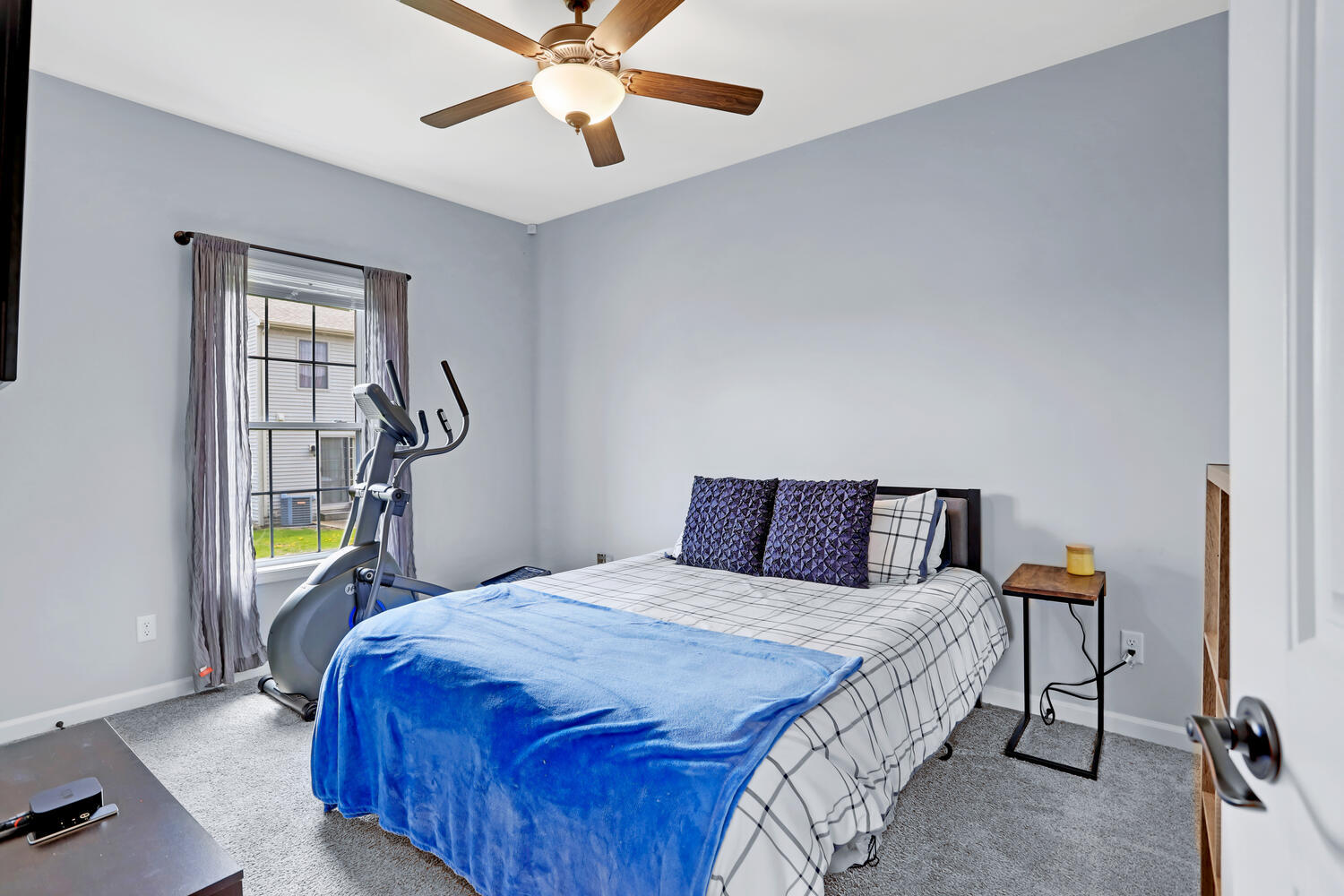 3323 Boulder Ridge Drive Champaign, IL 61822 - Photo 20 of 27 a bedroom with a bed and a chandelier