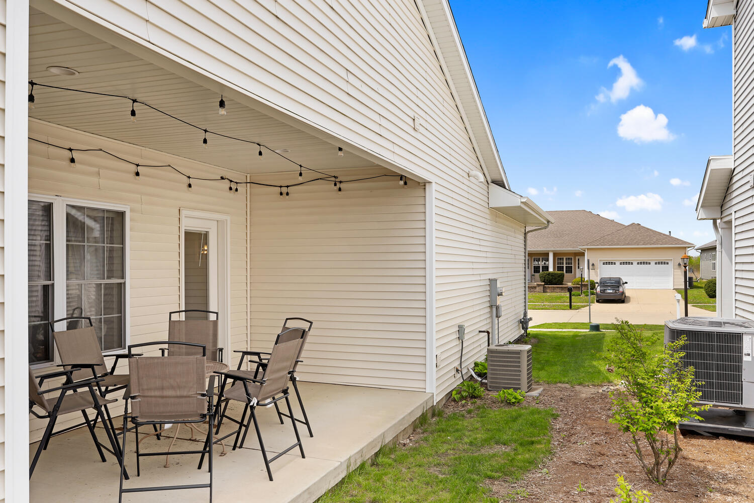 3323 Boulder Ridge Drive Champaign, IL 61822 - Photo 26 of 27 a view of a patio with table and chairs and potted plants