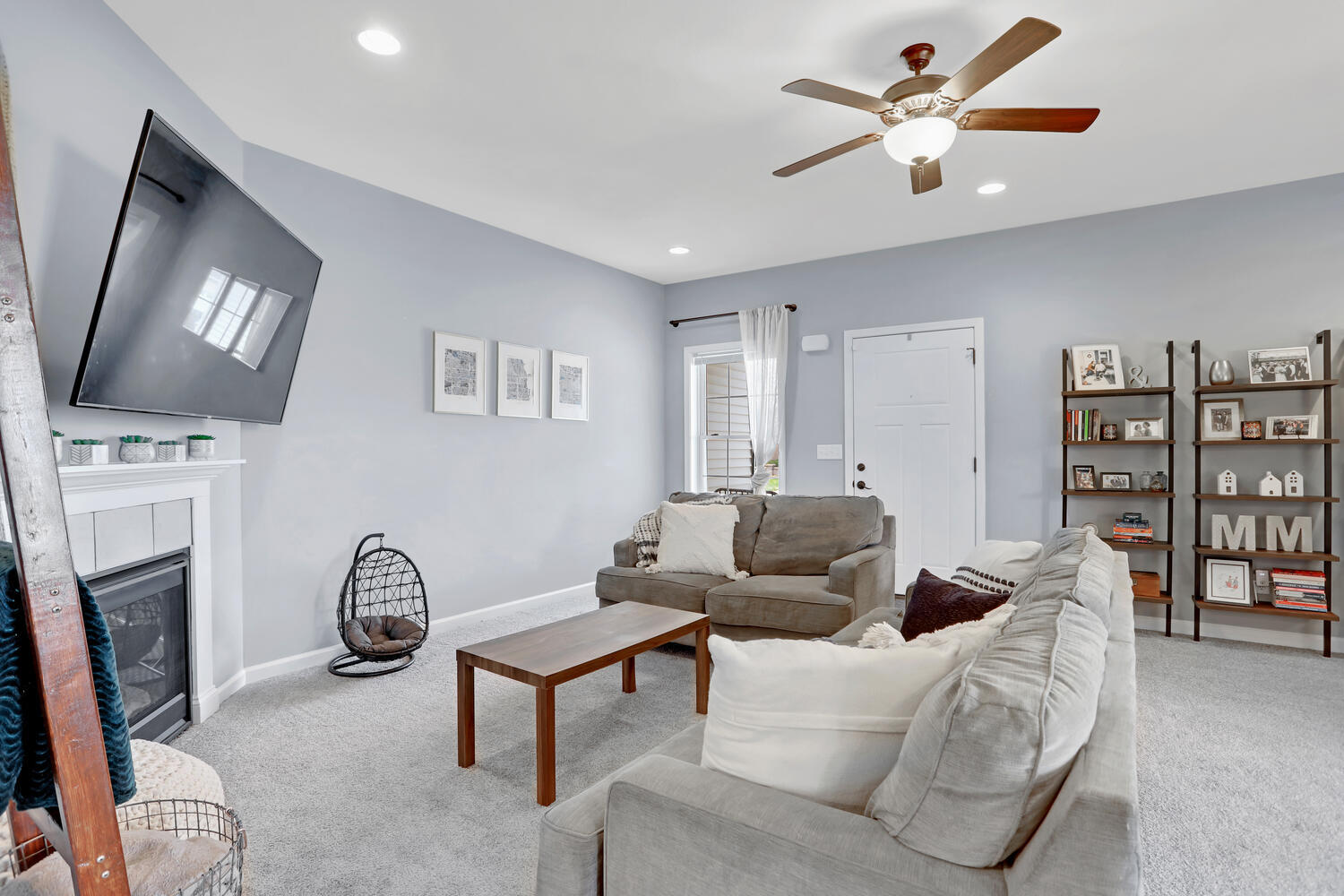 3323 Boulder Ridge Drive Champaign, IL 61822 - Photo 5 of 27 a living room with furniture a fireplace and a flat screen tv