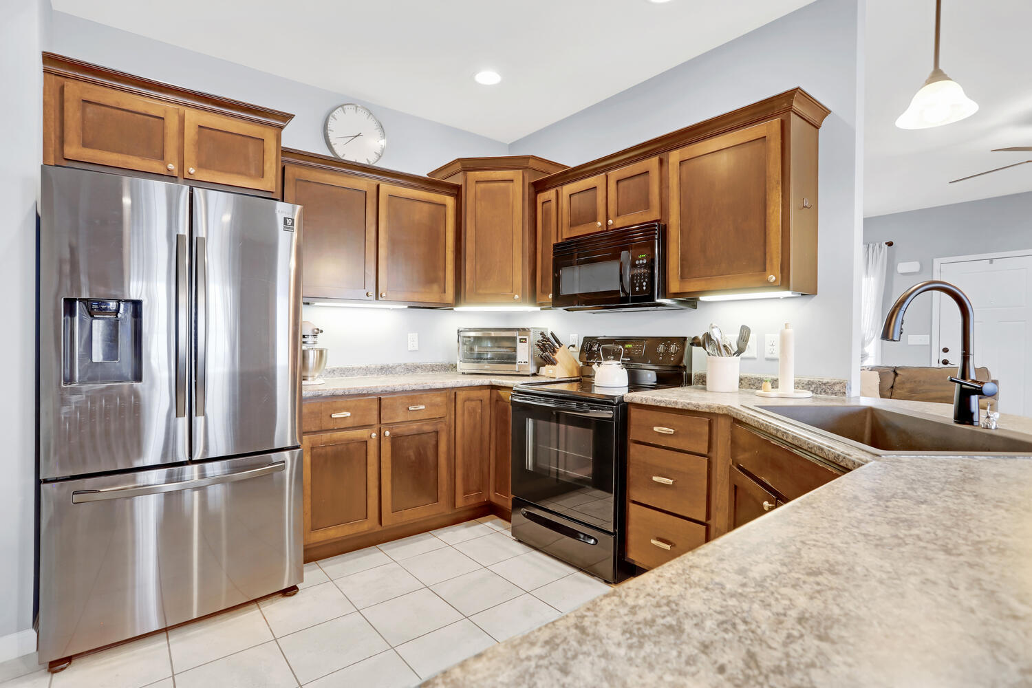 3323 Boulder Ridge Drive Champaign, IL 61822 - Photo 9 of 27 a kitchen with stainless steel appliances granite countertop a refrigerator a stove a sink and a microwave