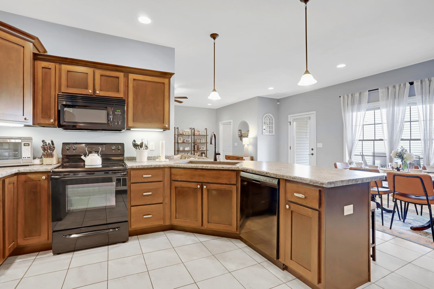 3323 Boulder Ridge Drive Champaign, IL 61822 - Photo 10 of 27 a kitchen with stainless steel appliances granite countertop a sink counter space cabinets and a window